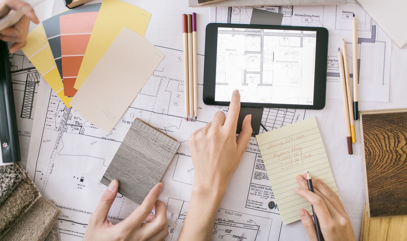 Designer reviewing finishes and floor plans