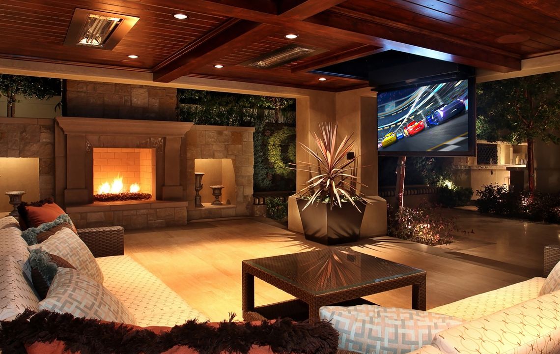 Outdoor dining area with immersive lighting and audio-video setup