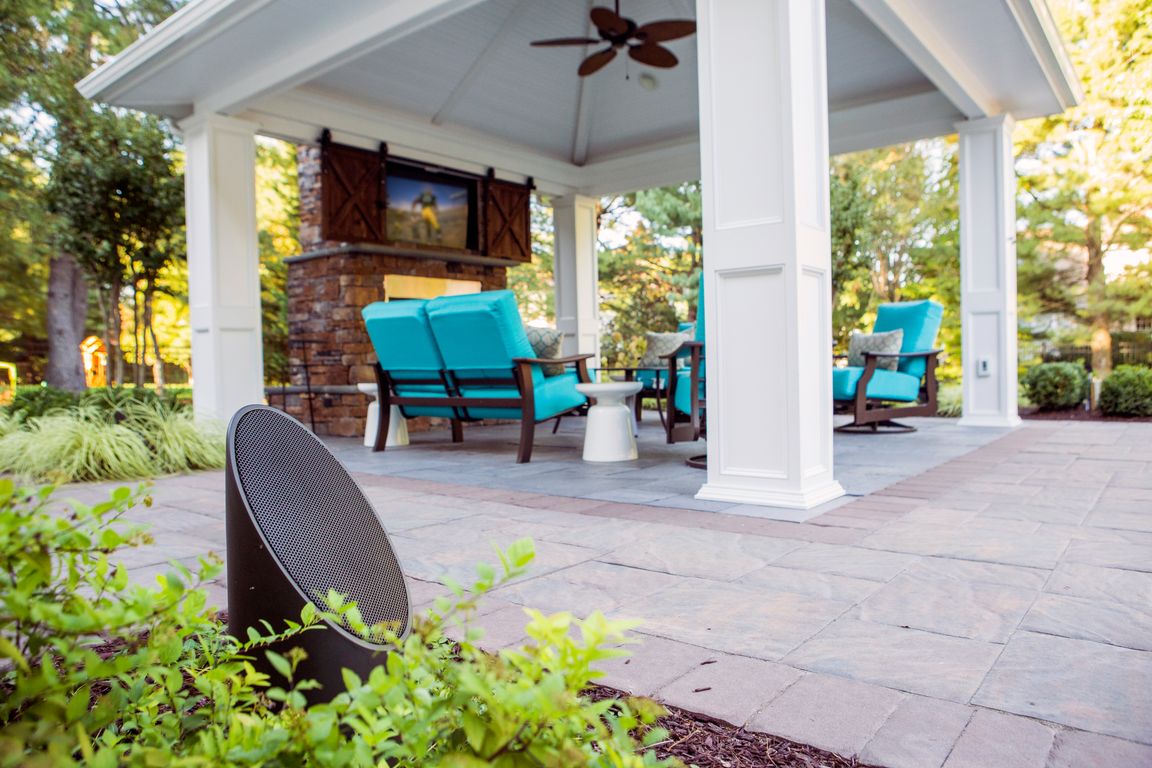 Lush garden with layered accent lighting and outdoor speakers